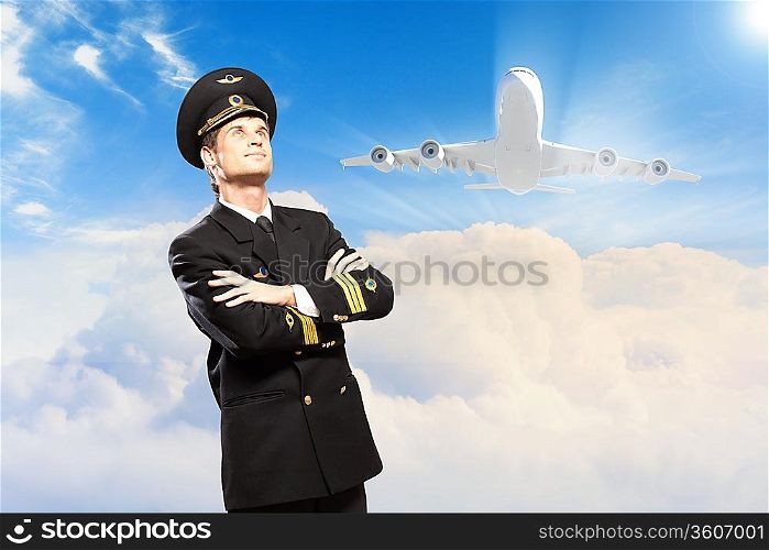 Image of male pilot with airplane at background