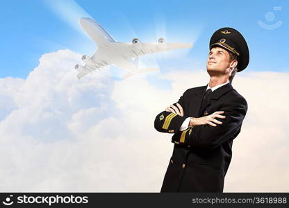 Image of male pilot with airplane at background