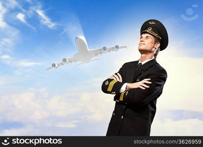 Image of male pilot with airplane at background