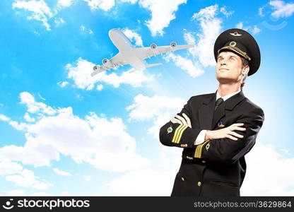 Image of male pilot with airplane at background