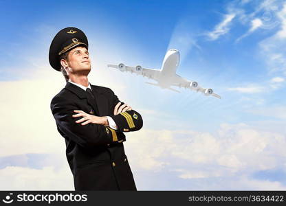 Image of male pilot with airplane at background