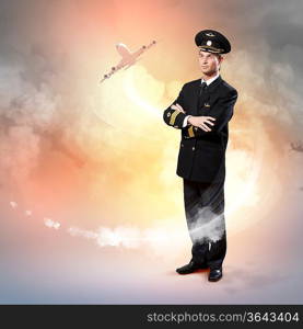 Image of male pilot with airplane flying around him