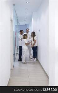 Image of medical workers talking in clinic corridor
