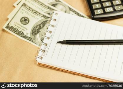 Image of money and a calculator, home budget