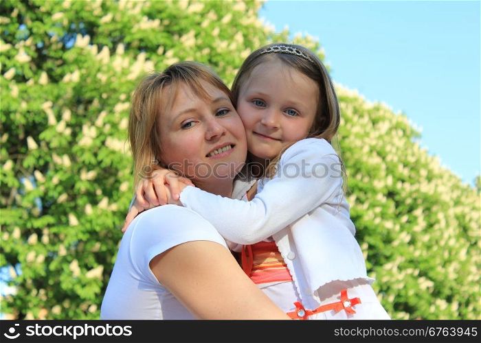 image of mother and daughter are hugging one another