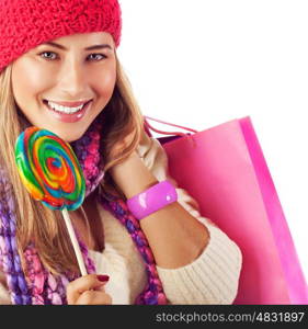 Image of nice blond girl wearing warm winter red hat and eating tasty sugar candy, sweets shop, Christmas present bag, stylish accessories, New Year goody-goody, christmastime holidays