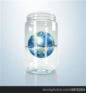 Image of our planet earth inside a glass jar