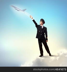 Image of pilot touching air. Image of pilot touching sky against airplane background