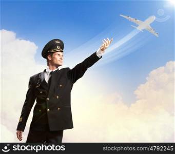 Image of pilot touching air. Image of pilot touching sky against airplane background