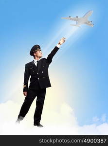 Image of pilot touching air. Image of pilot touching sky against airplane background