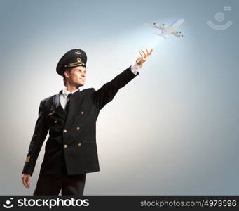 Image of pilot touching air. Image of pilot touching sky against airplane background