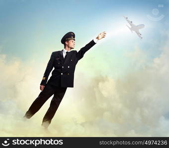 Image of pilot touching air. Image of pilot touching sky against airplane background