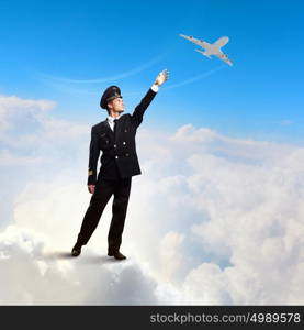 Image of pilot touching air. Image of pilot touching sky against airplane background