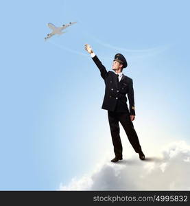 Image of pilot touching air. Image of pilot touching sky against airplane background