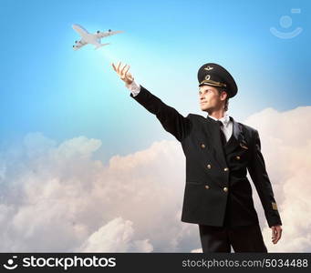 Image of pilot touching air. Image of pilot touching sky against airplane background