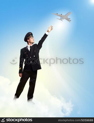 Image of pilot touching air. Image of pilot touching sky against airplane background