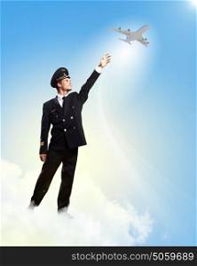 Image of pilot touching air. Image of pilot touching sky against airplane background