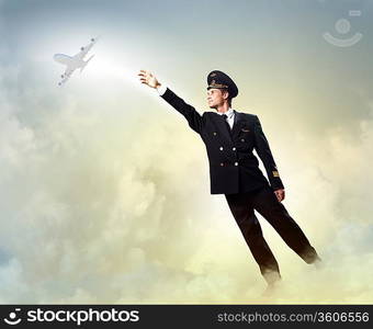 Image of pilot touching sky against airplane background