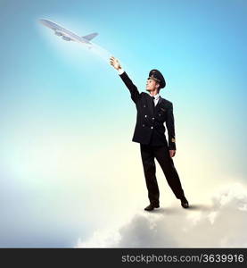 Image of pilot touching sky against airplane background