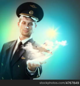 Image of pilot with plane in hand. Image of pilot with airplane taking off from his hand