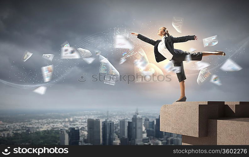 Image of pretty businesswoman balancing on the roof above cityscape