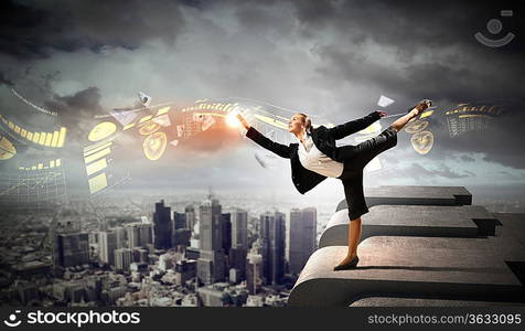 Image of pretty businesswoman balancing on the roof above cityscape