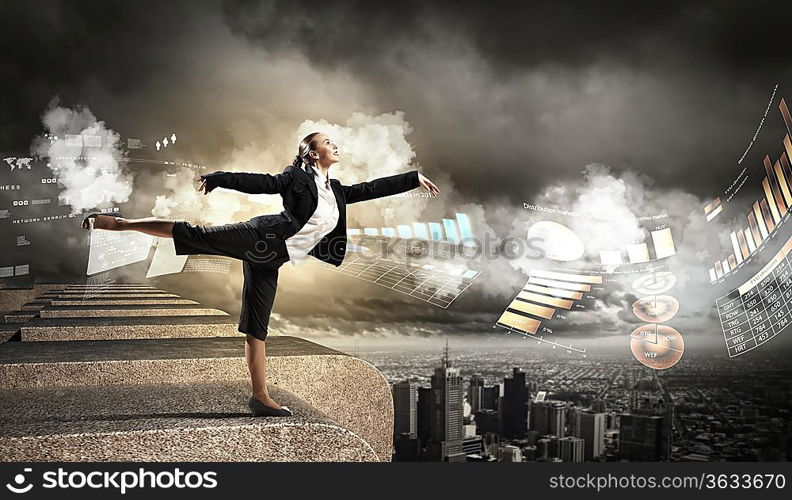 Image of pretty businesswoman balancing on the roof above cityscape