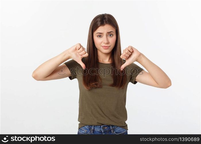 Image of resentful woman with long dark hair showing thumbs down isolated over gray background. Image of resentful woman with long dark hair showing thumbs down isolated over gray background.