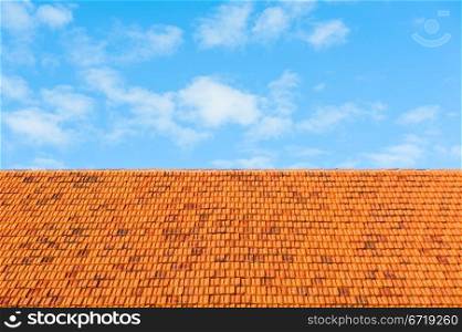 image of roof tiles and sky with clouds