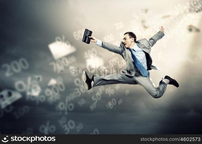 Image of running businessman. Image of a businessman jumping high against financial background