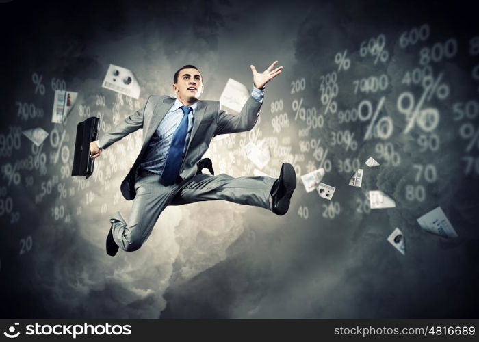 Image of running businessman. Image of a businessman jumping high against financial background