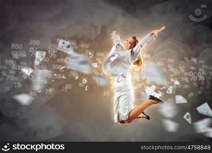 Image of running businesswoman. Image of a businesswoman jumping high against financial background