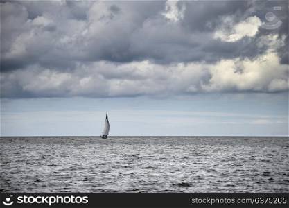 Image of sailing boat with stormy dramatic sky clouds overhead