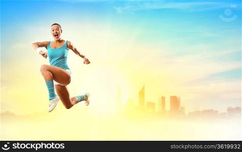 Image of sport girl in jump against city background
