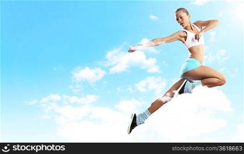 Image of sport girl in jump against cloudy background