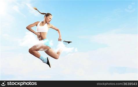 Image of sport girl in jump against cloudy background
