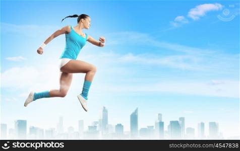 Image of sport woman jumping. Image of sport girl in jump against city background