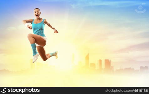 Image of sport woman jumping. Image of sport girl in jump against city background