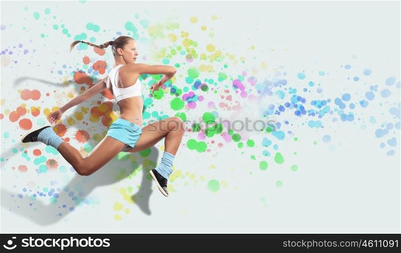 Image of sport woman jumping. Image of sport girl in jump against color spot background