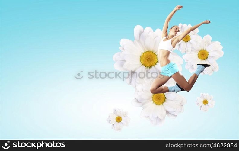 Image of sport woman jumping. Image of sport girl in jump against flower background