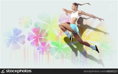 Image of sport woman jumping. Image of sport girl in jump against flower background