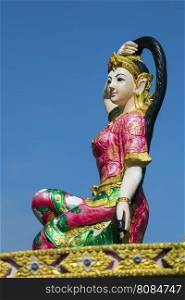 Image of statue of a beautiful woman on sky background. The Sculpture of holy mother earth.