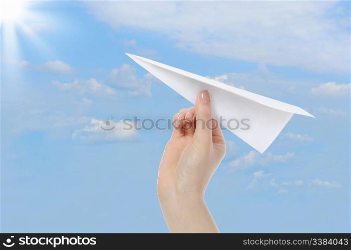 image of the businesswoman throwing white paper plane.