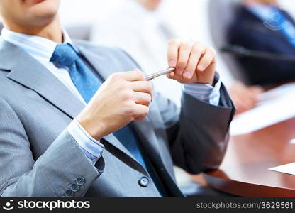 Image of three businesspeople at table at conference