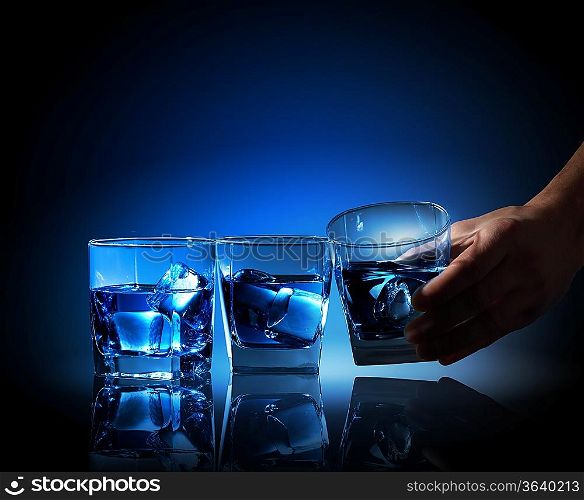 Image of three glasses of blue liquid with ice