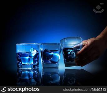 Image of three glasses of blue liquid with ice