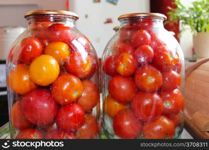 image of tomatos in jars prepared for preservation