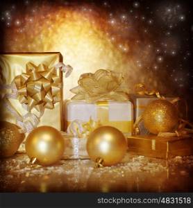 Image of traditional New Year gifts, Christmas present box wrapping in shiny golden festive paper, Christmastime still life isolated on dark glowing background, Xmas eve, holiday surprise