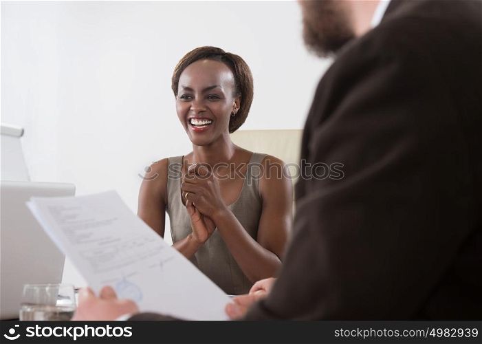 Image of two young businesspeople of diverse ethnicity businessman and businesswoman at meeting