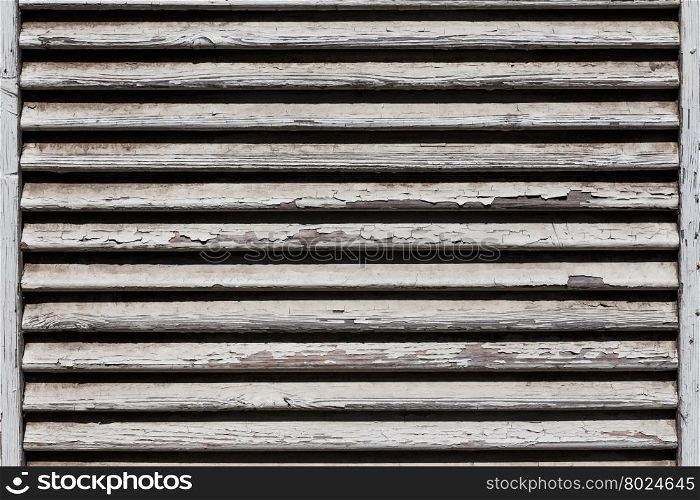 Image of white wooden shutters, covering a window or door
